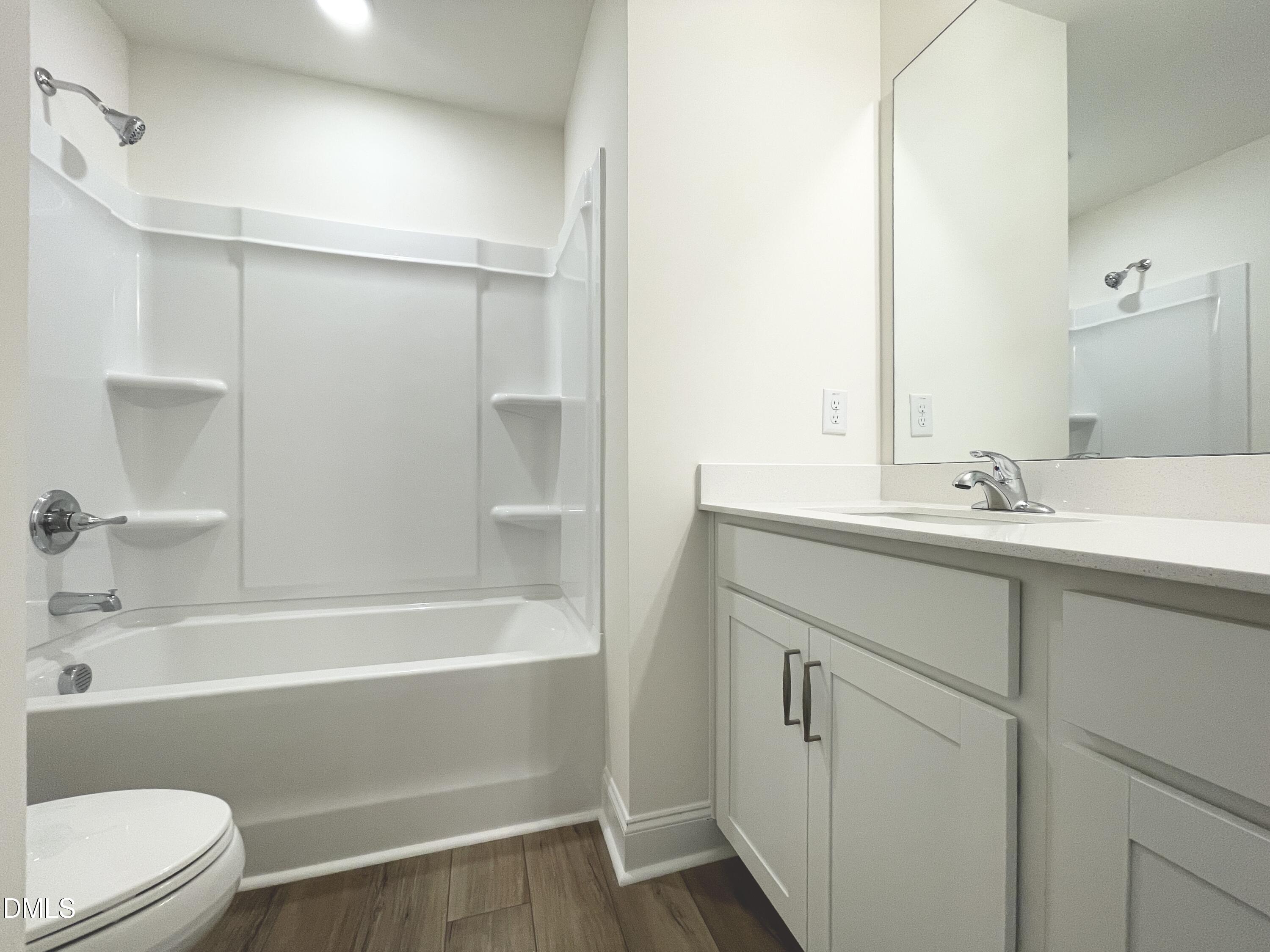 6429 Granite Quarry Drive Raleigh, NC 27610 - Photo 18 of 21 a bathroom with a bathtub shower sink vanity and toilet
