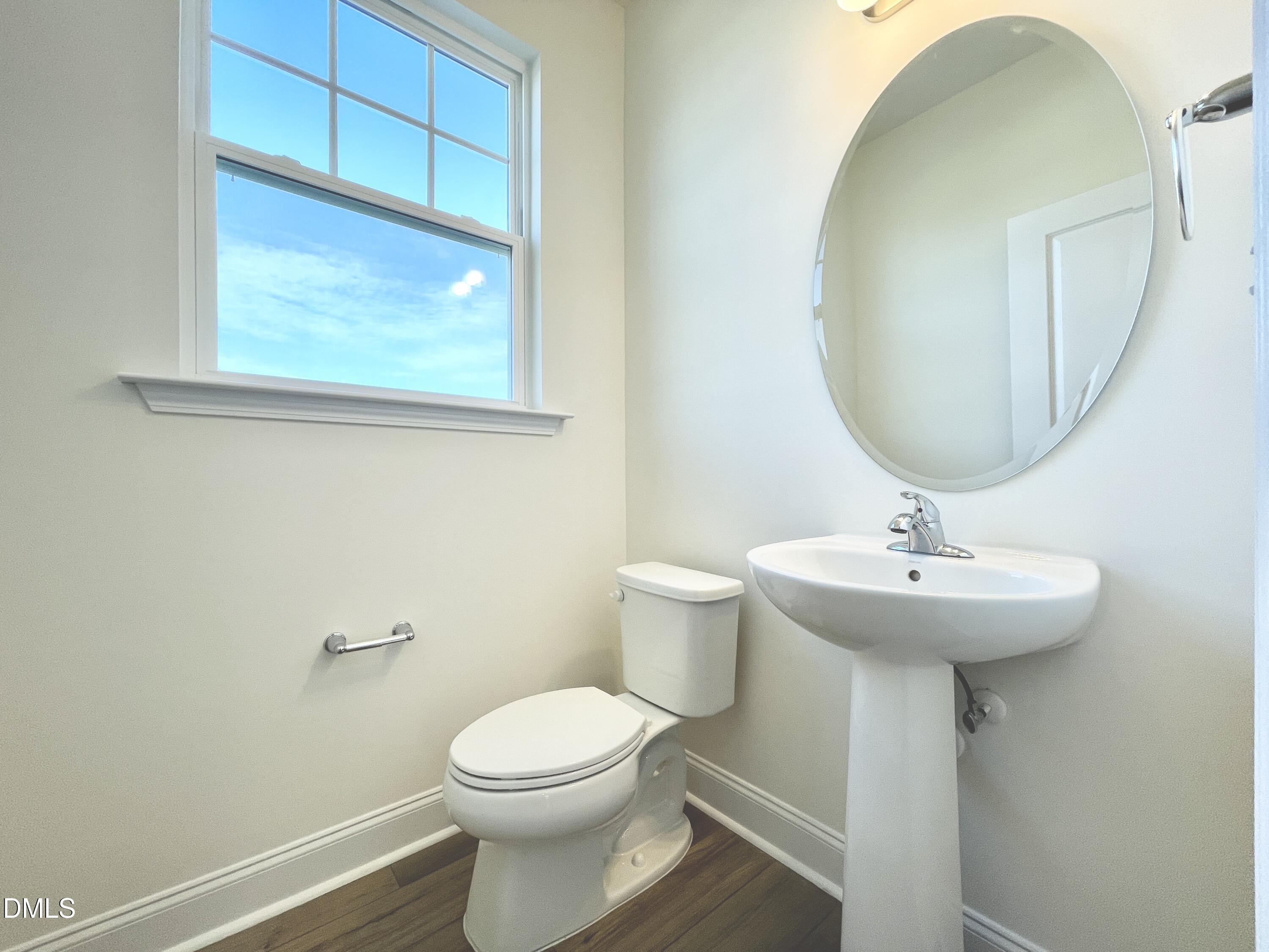 6429 Granite Quarry Drive Raleigh, NC 27610 - Photo 21 of 21 a bathroom with a sink a mirror and toilet