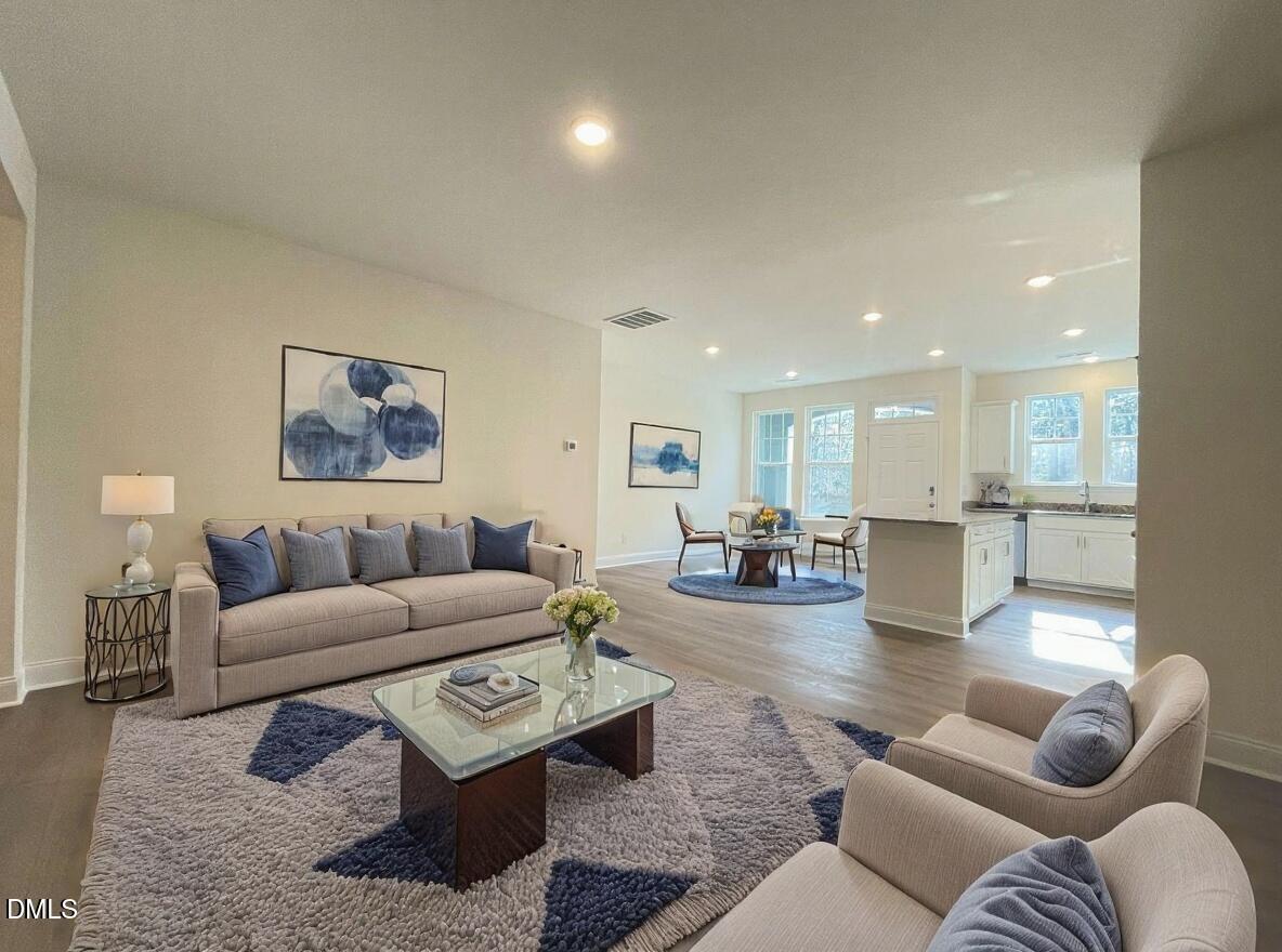 6429 Granite Quarry Drive Raleigh, NC 27610 - Photo 3 of 21 a living room with furniture and a wooden floor