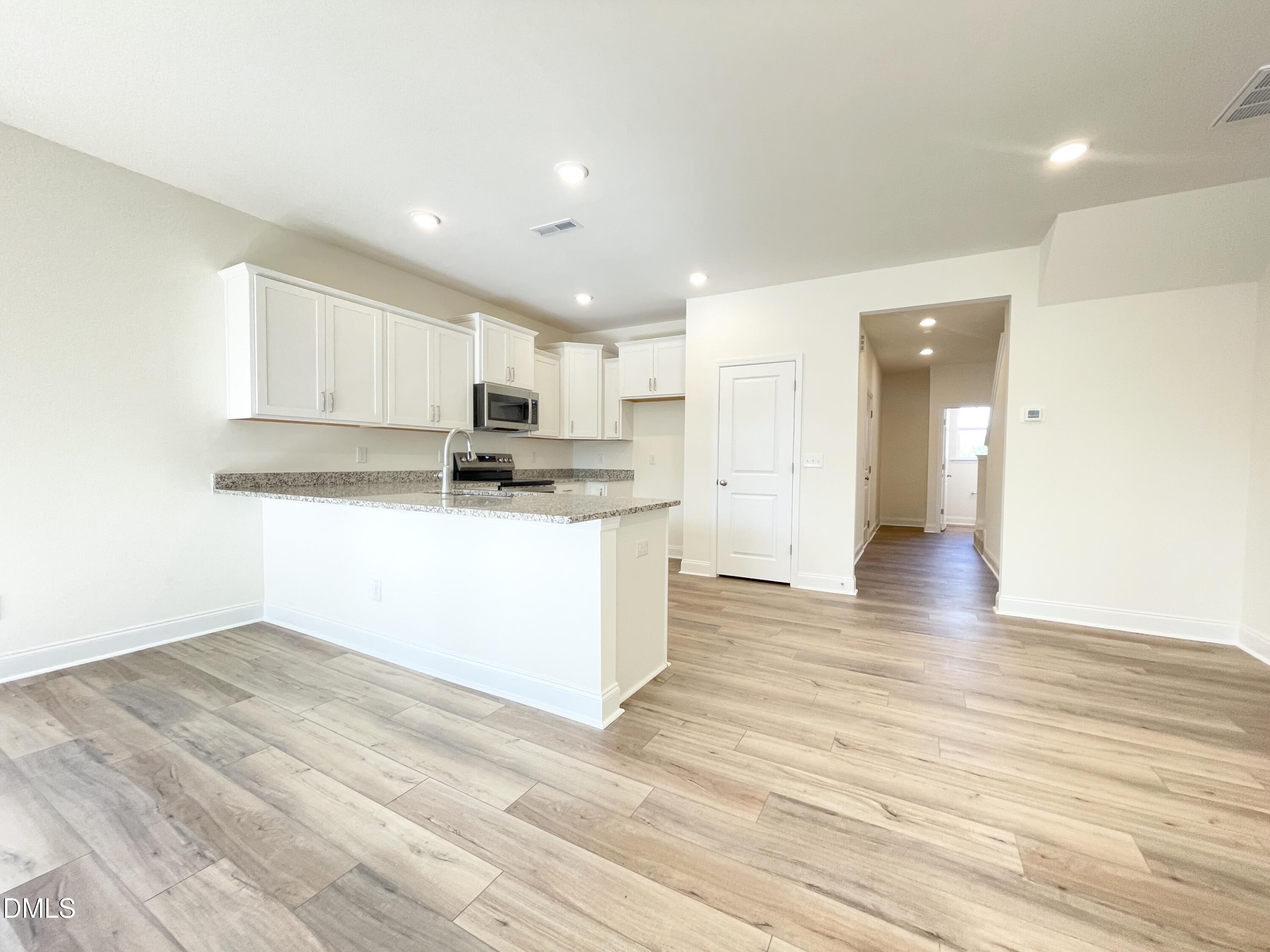 6429 Granite Quarry Drive Raleigh, NC 27610 - Photo 5 of 21 a view of kitchen with kitchen island wooden floor center island and stainless steel appliances