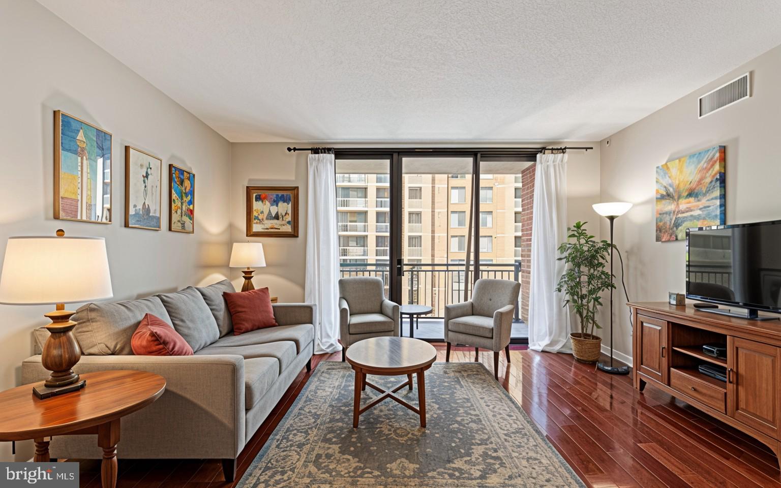 11710 Old Georgetown Road, Unit 1007 North Bethesda, MD 20852 - Photo 14 of 30 a living room with furniture a flat screen tv and a large window