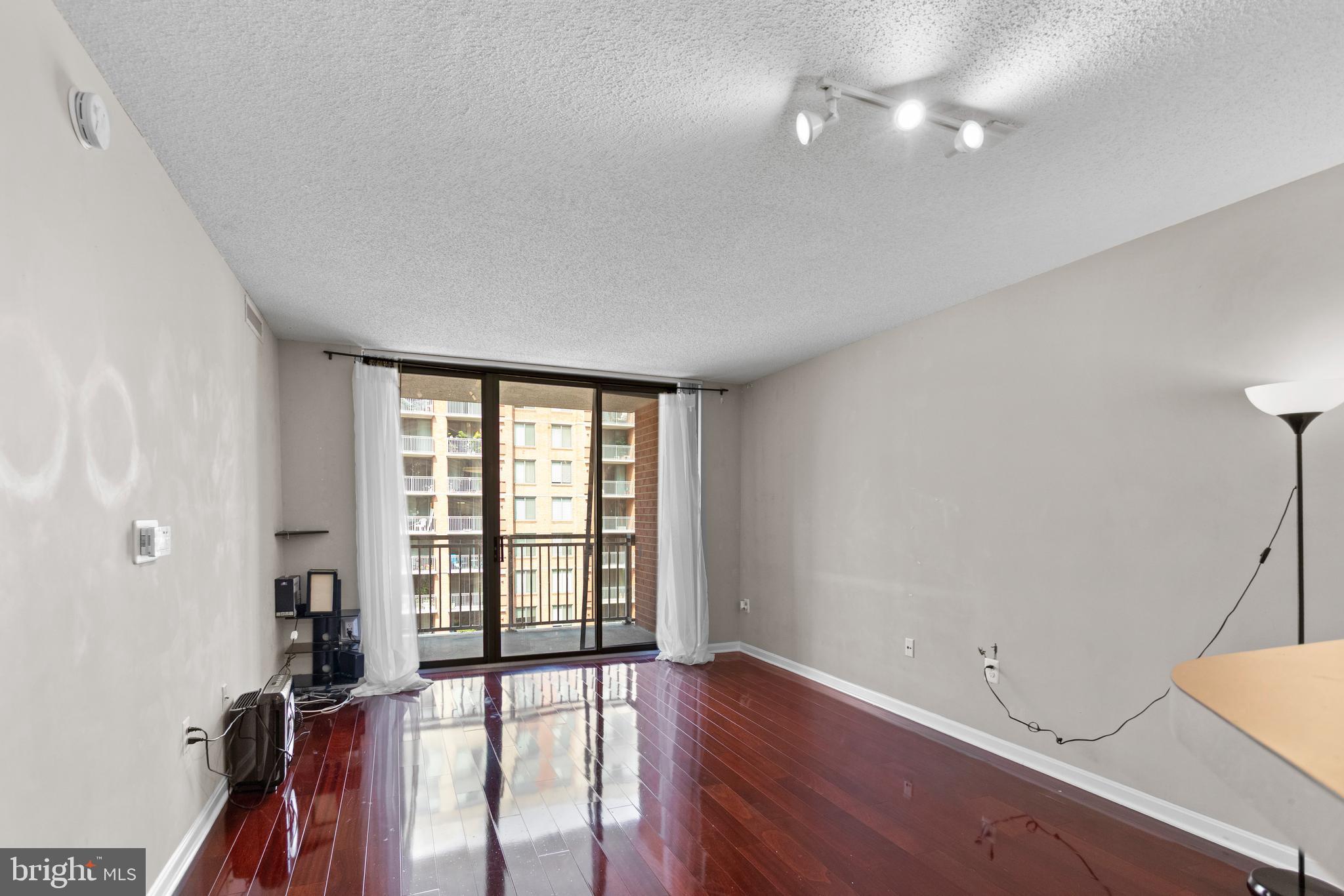 11710 Old Georgetown Road, Unit 1007 North Bethesda, MD 20852 - Photo 15 of 30 wooden floor in an empty room with a window