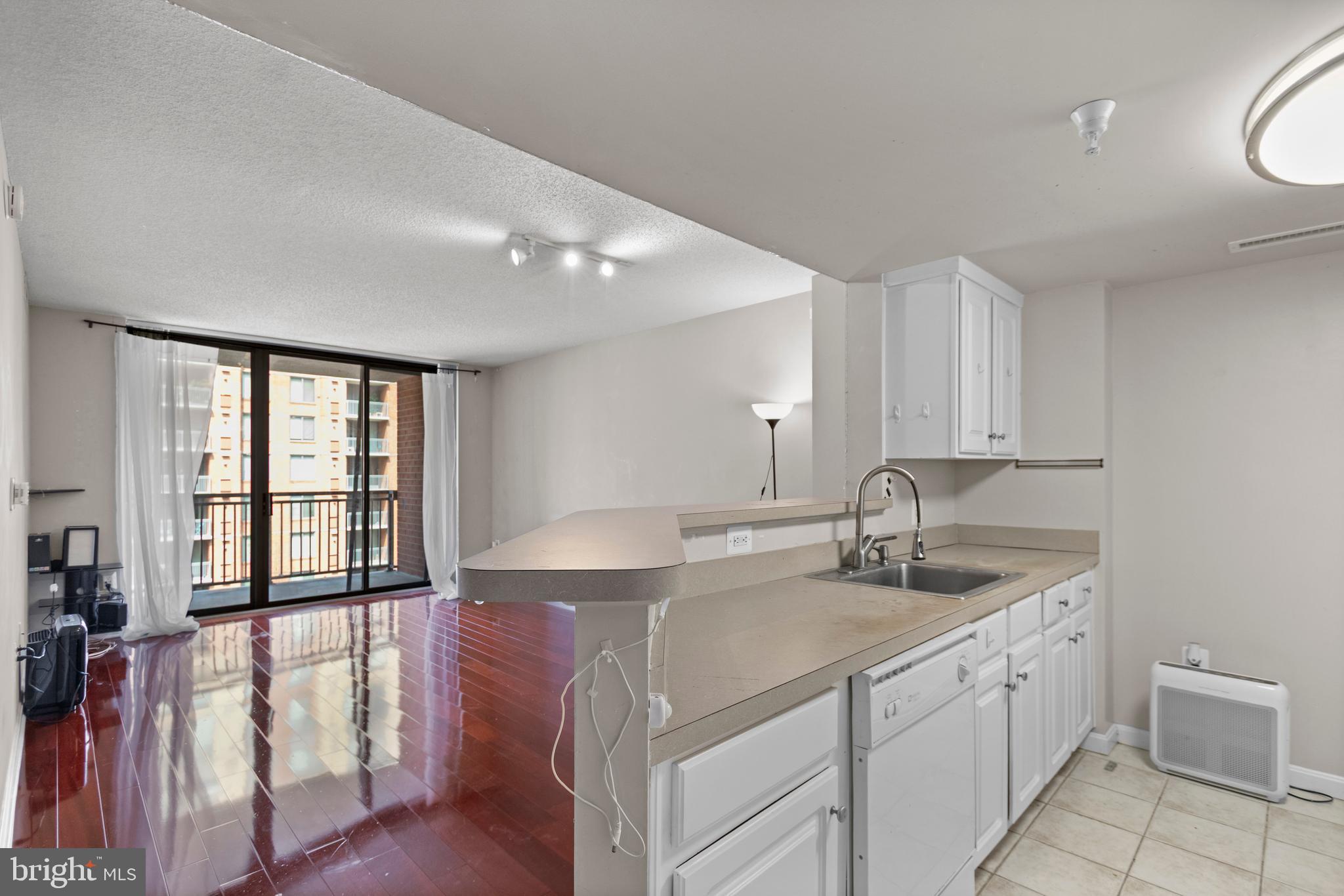 11710 Old Georgetown Road, Unit 1007 North Bethesda, MD 20852 - Photo 30 of 30 a kitchen with a sink cabinets and wooden floor
