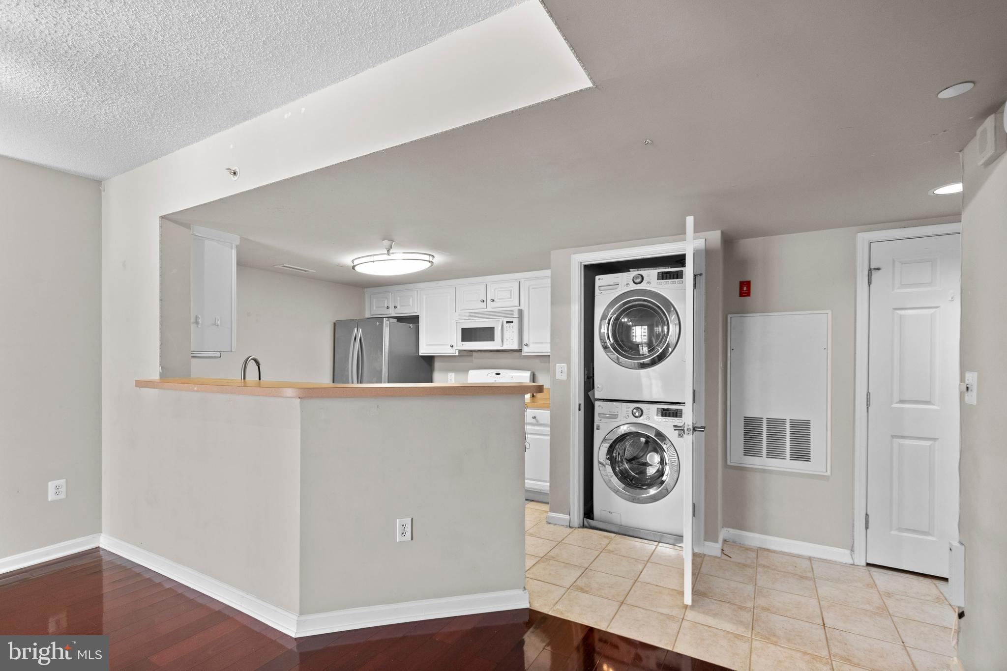 11710 Old Georgetown Road, Unit 1007 North Bethesda, MD 20852 - Photo 23 of 30 a view of kitchen and washer and dryer