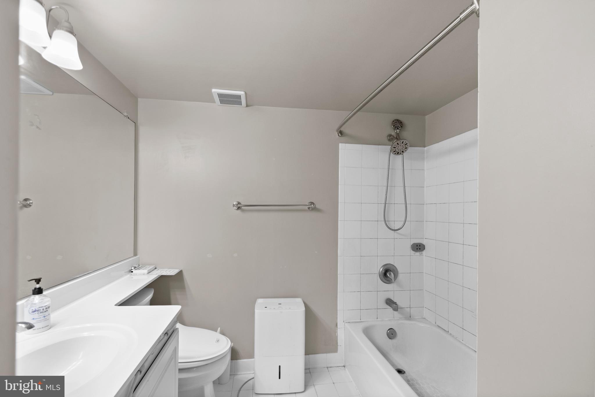 11710 Old Georgetown Road, Unit 1007 North Bethesda, MD 20852 - Photo 24 of 30 a bathroom with a sink toilet vanity and shower