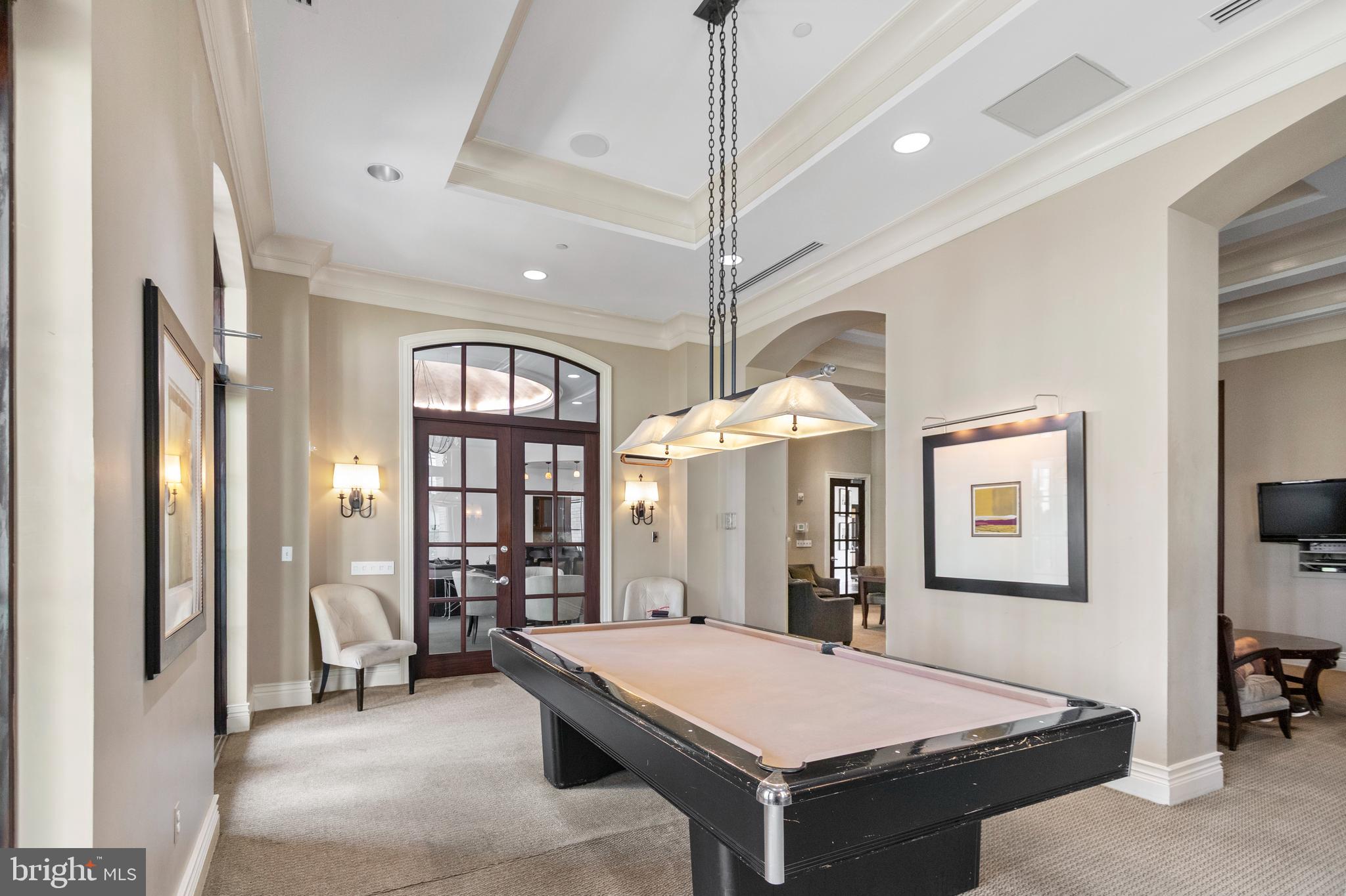 11710 Old Georgetown Road, Unit 1007 North Bethesda, MD 20852 - Photo 4 of 30 a living room with a table chairs and a chandelier