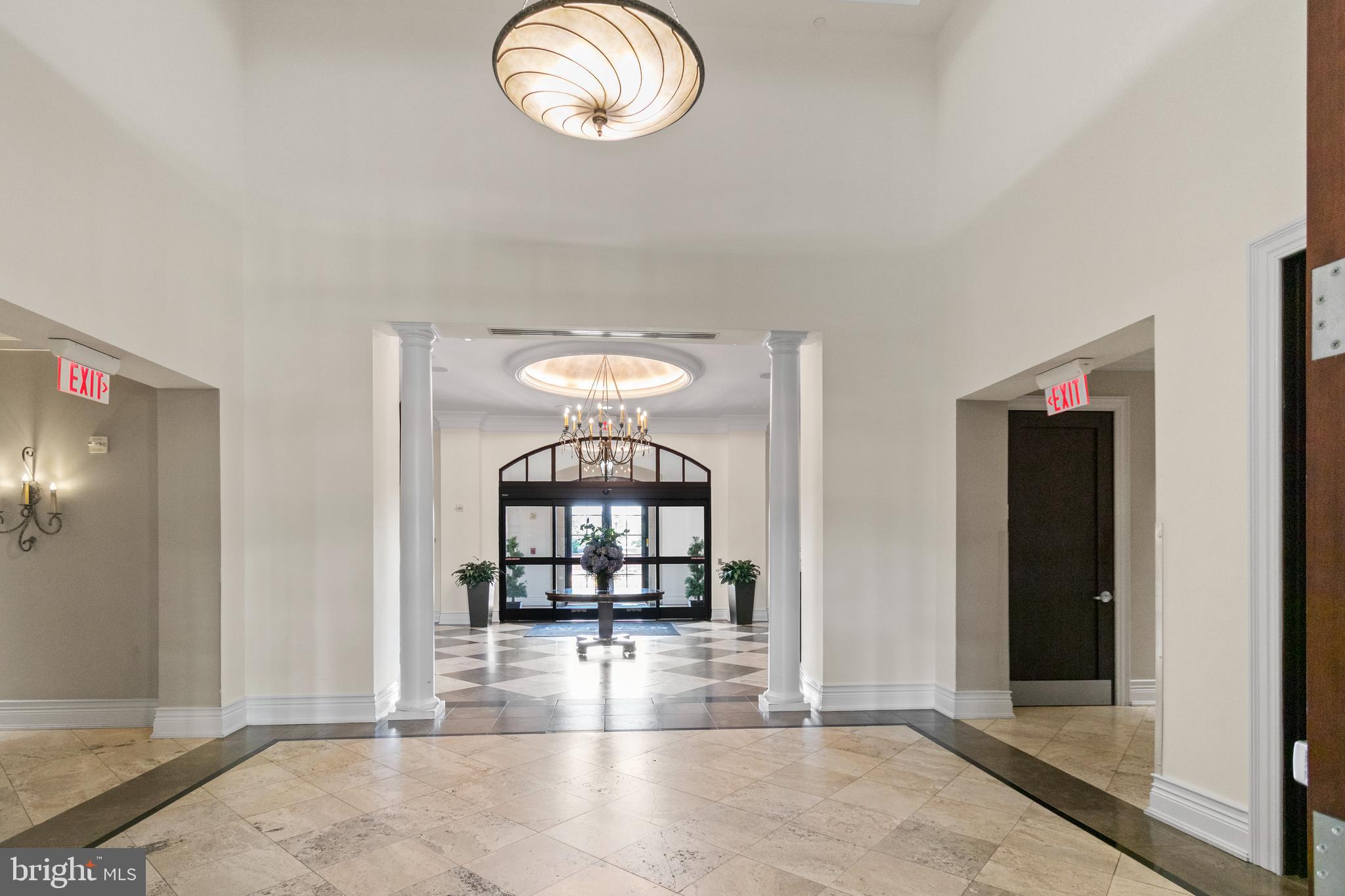 11710 Old Georgetown Road, Unit 1007 North Bethesda, MD 20852 - Photo 5 of 30 an empty room with windows and chandelier