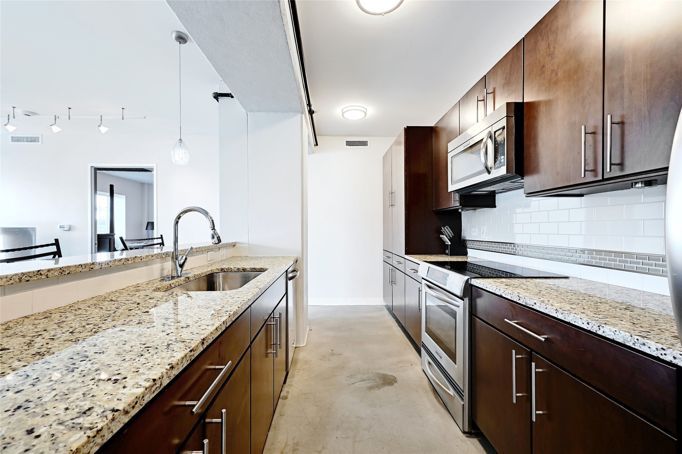 800 Brazos Street, Unit 705 Austin, TX 78701 - Photo 12 of 33 a kitchen with stainless steel appliances granite countertop a sink a stove and a refrigerator