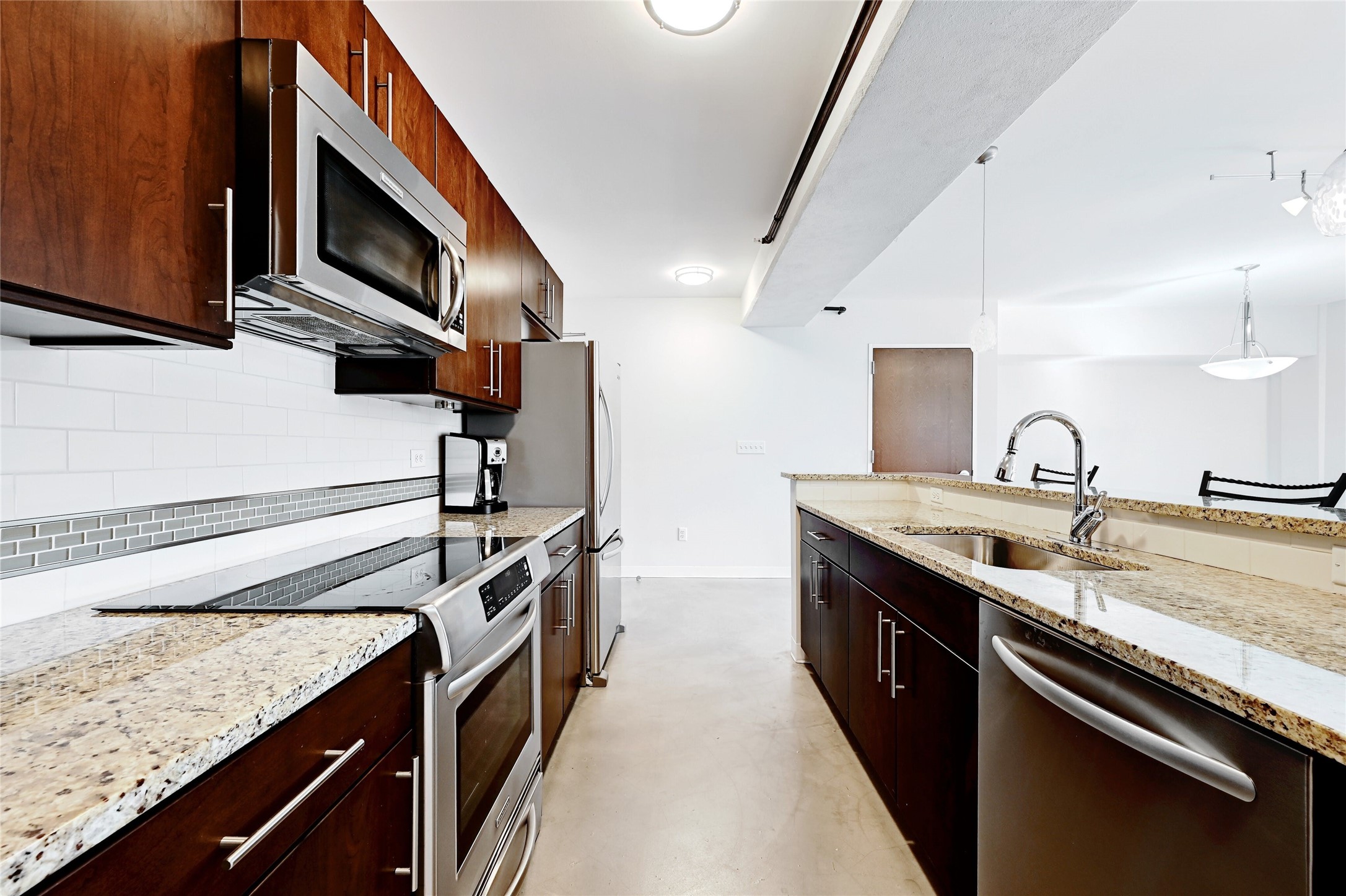 800 Brazos Street, Unit 705 Austin, TX 78701 - Photo 13 of 33 a kitchen with a sink and stainless steel appliances