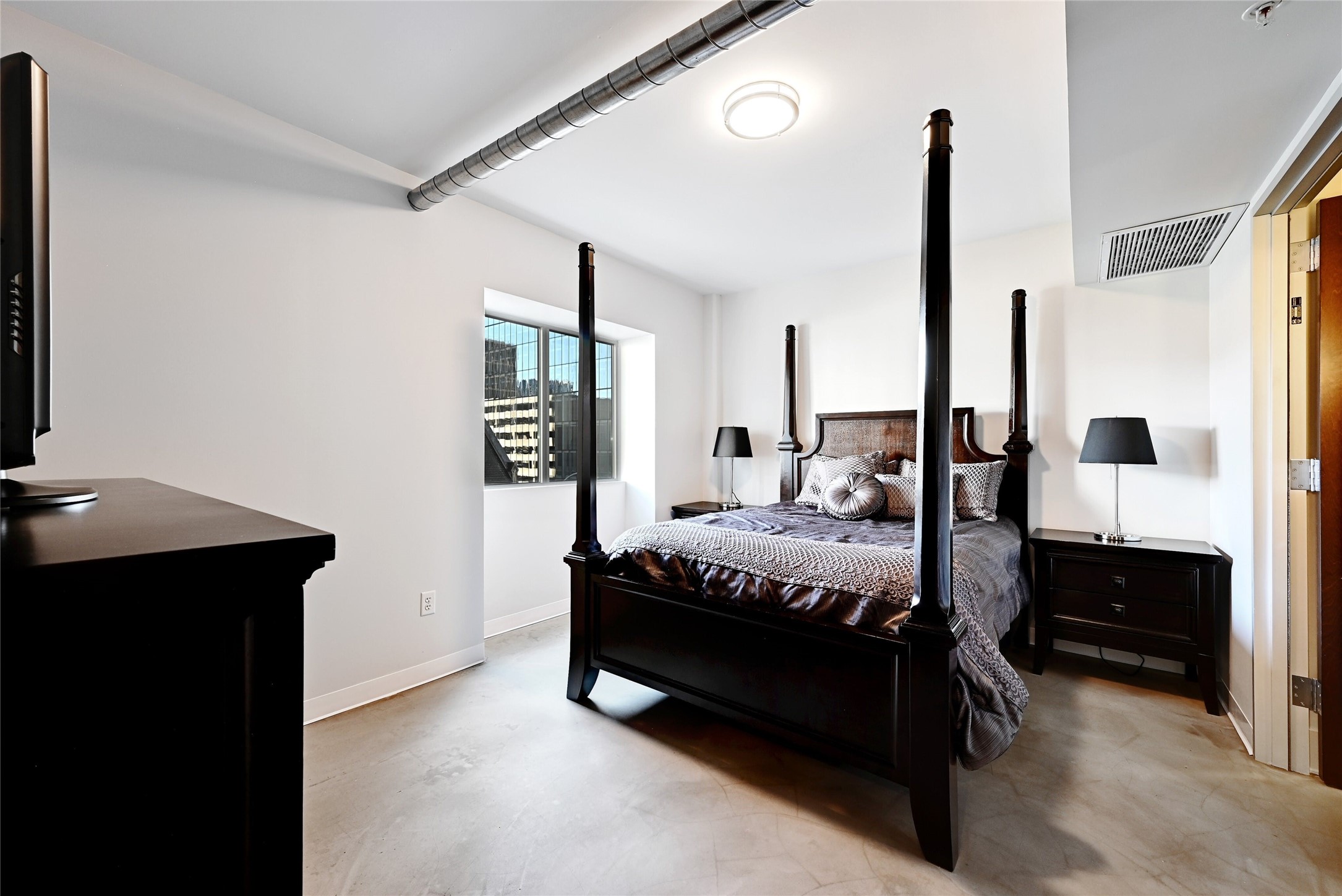 800 Brazos Street, Unit 705 Austin, TX 78701 - Photo 14 of 33 a bedroom with a bed window and a table