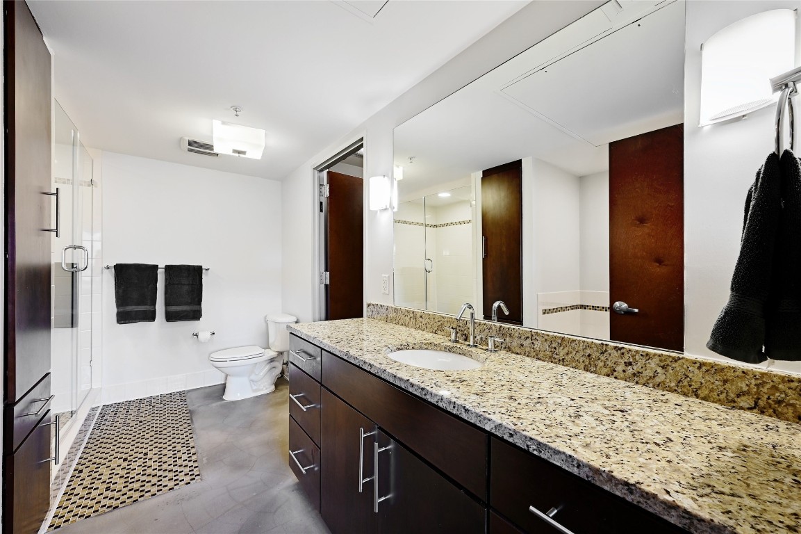 800 Brazos Street, Unit 705 Austin, TX 78701 - Photo 17 of 34 a bathroom with a granite countertop sink and a mirror