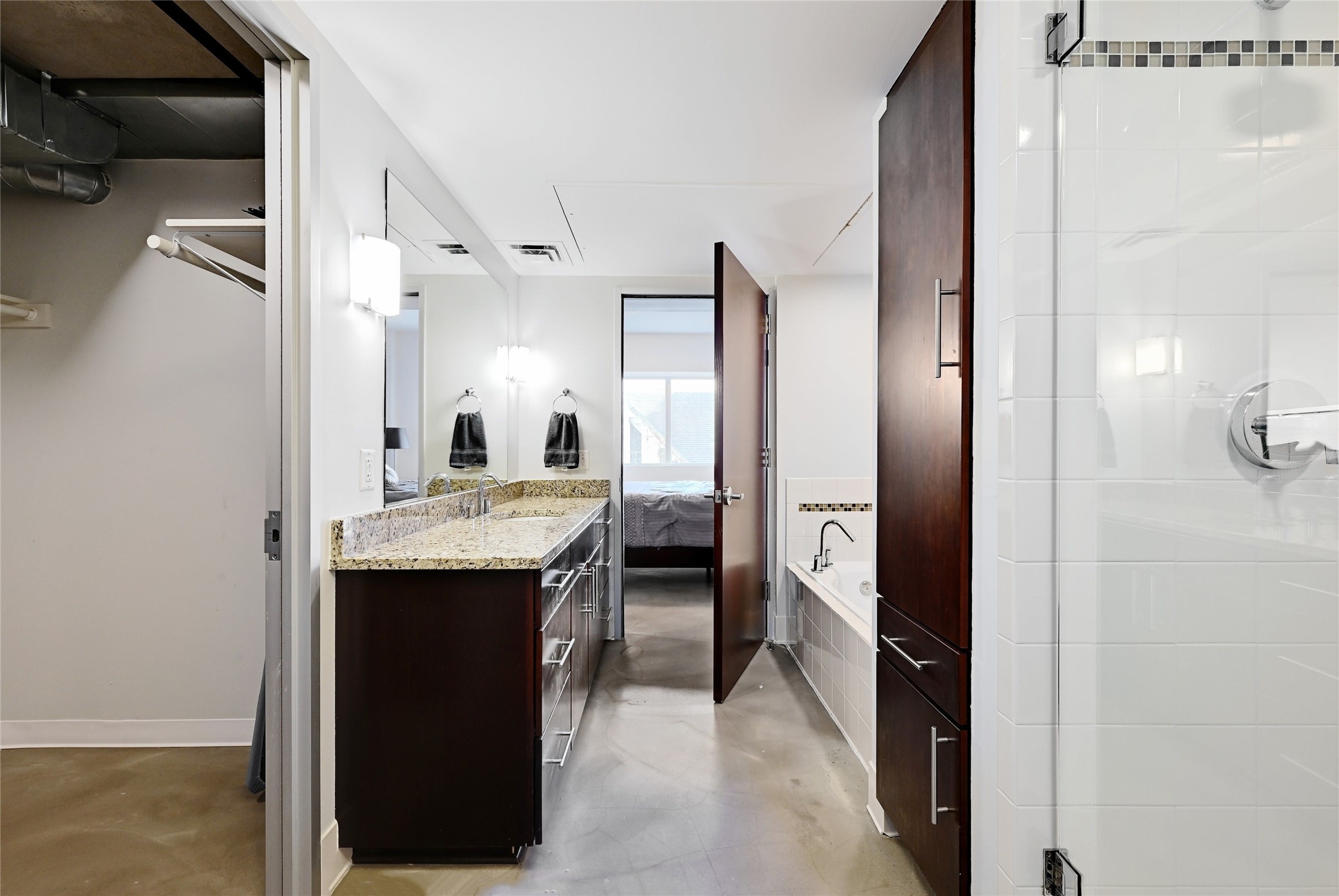 800 Brazos Street, Unit 705 Austin, TX 78701 - Photo 19 of 33 a large bathroom with a granite countertop sink and a mirror