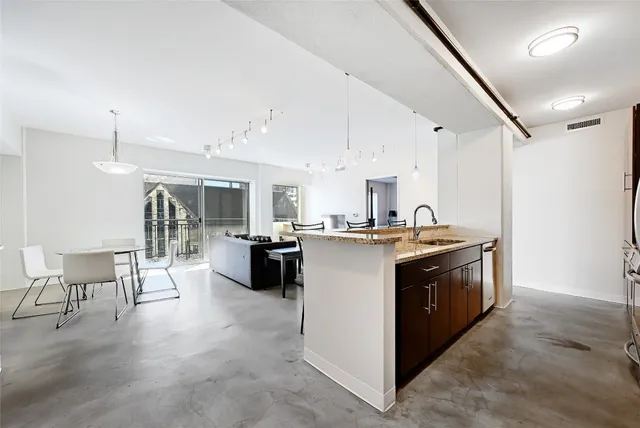 a kitchen with stainless steel appliances granite countertop a stove and a refrigerator