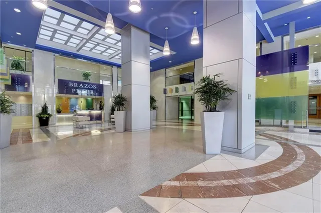 a front view of a building with outdoor seating and windows