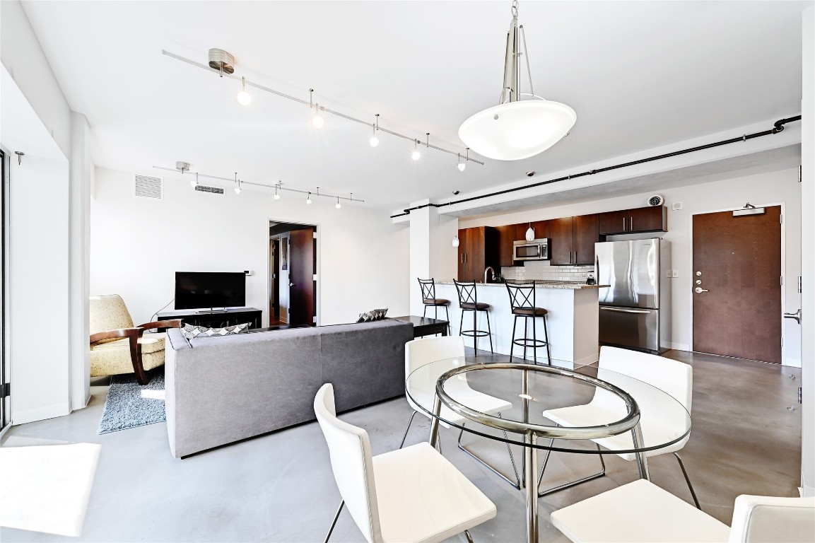 800 Brazos Street, Unit 705 Austin, TX 78701 - Photo 7 of 34 a living room with furniture kitchen view and a chandelier