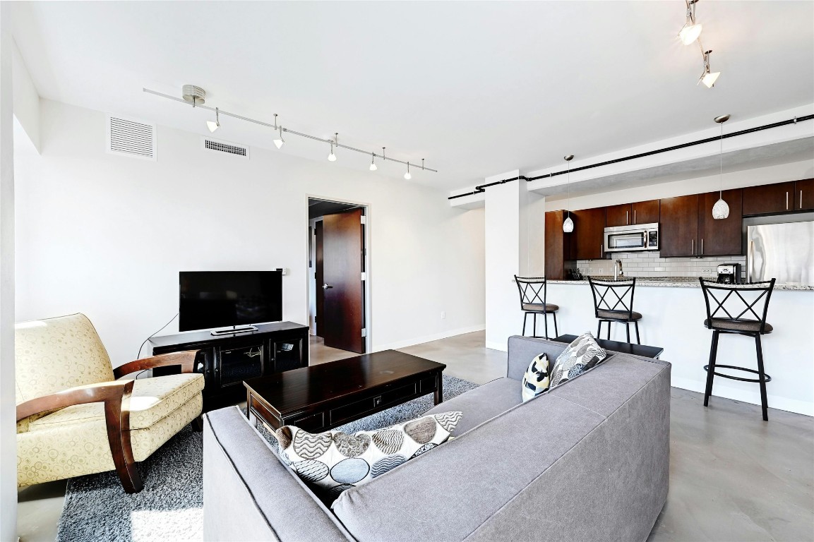 800 Brazos Street, Unit 705 Austin, TX 78701 - Photo 8 of 34 a living room with furniture and a flat screen tv