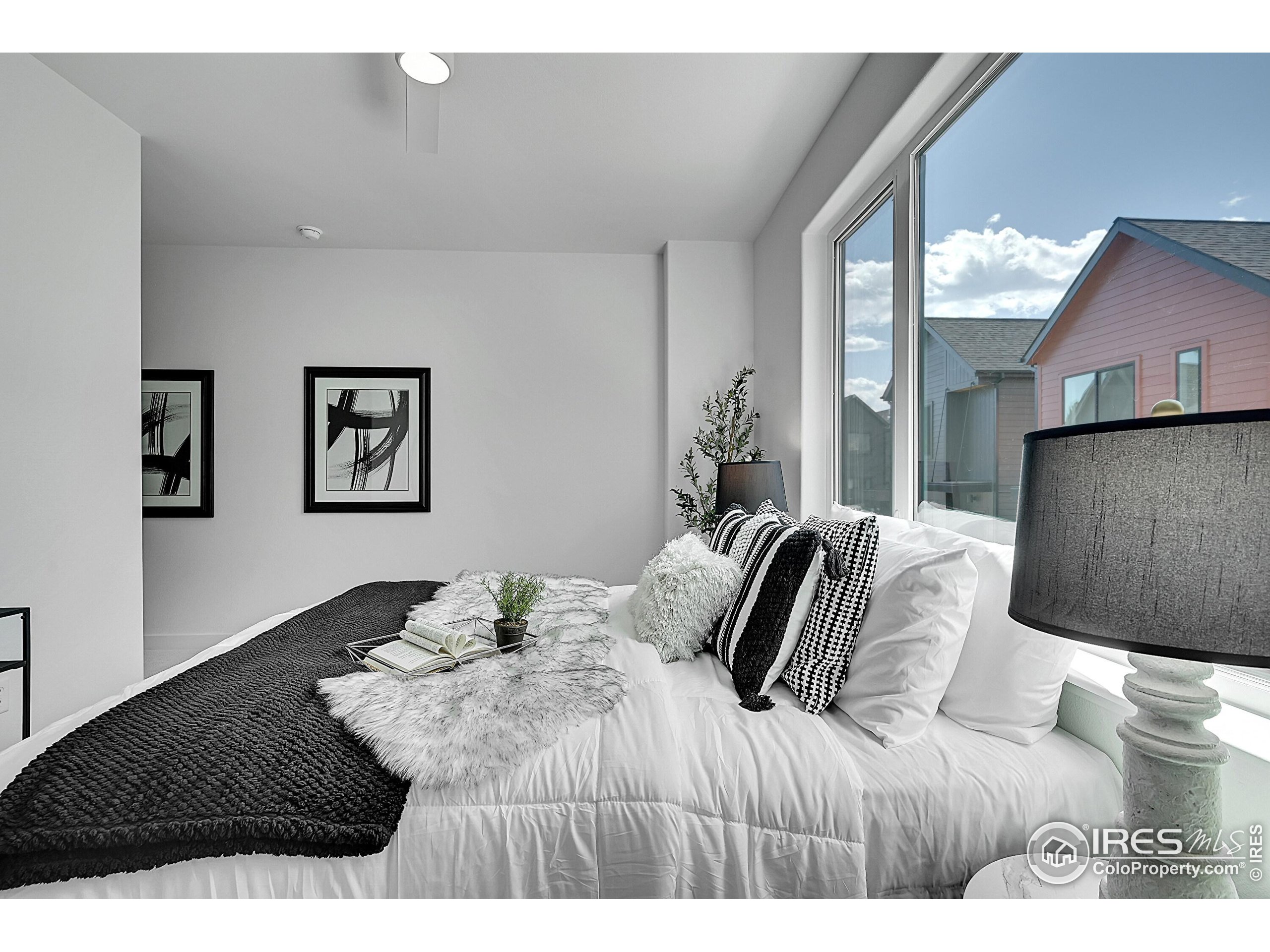 783 East County Line Road Erie, CO 80516 - Photo 15 of 28 a bedroom with a large bed and a painting on the wall