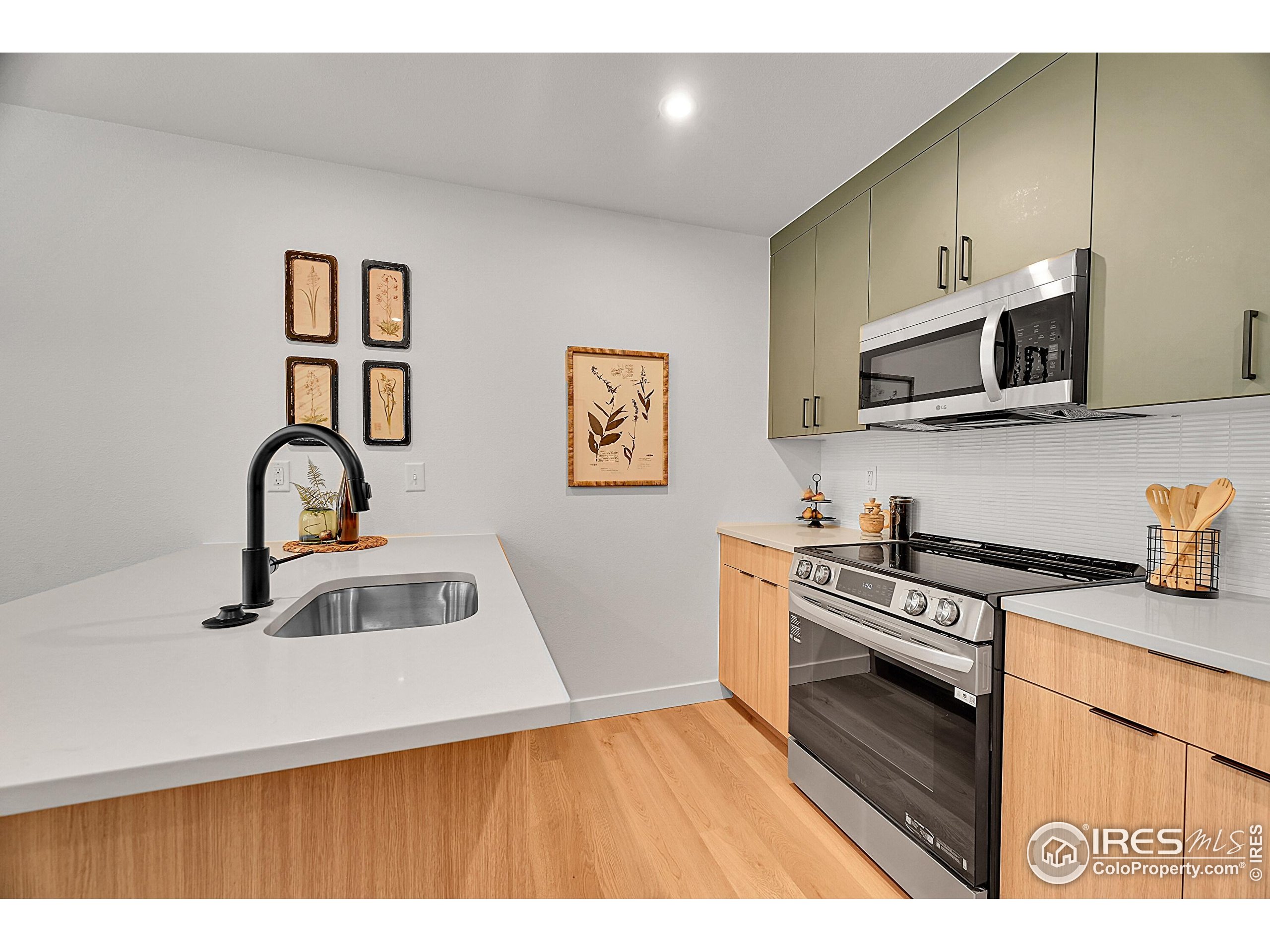 783 East County Line Road Erie, CO 80516 - Photo 6 of 28 a kitchen with stainless steel appliances granite countertop a sink and a stove top oven