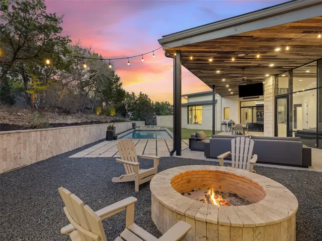 an aerial view of a house with a yard and trees