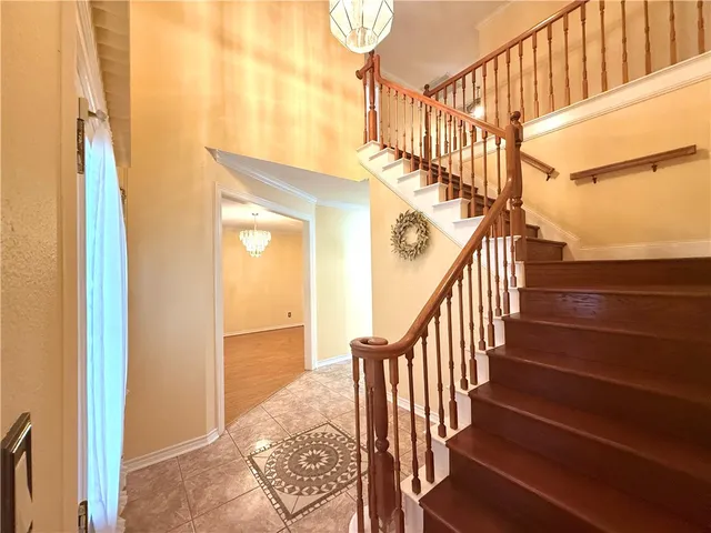 a view of a livingroom with wooden floor and a ceiling fan