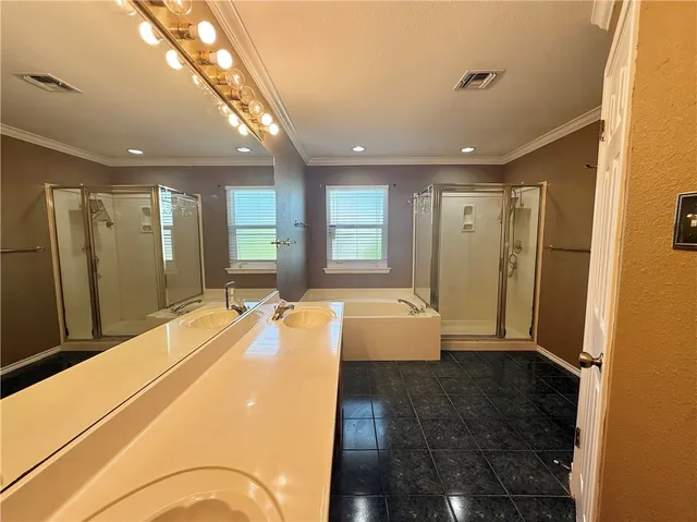a bathroom with a tub and shower