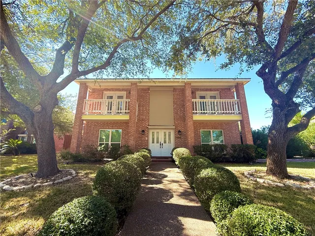 a view of a tree in front of a house