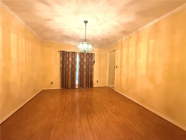 a view of a room with wooden floor gym equipment and windows