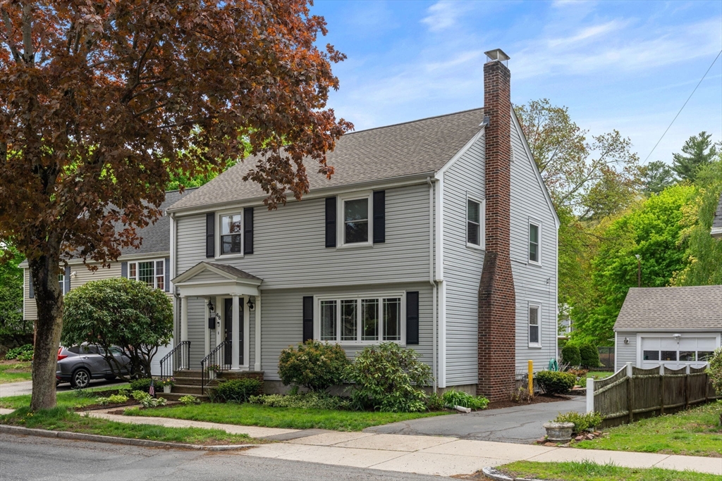 48 Spring Street Wakefield, MA 01880 - Photo 1 of 28 a front view of a house with trees and plants