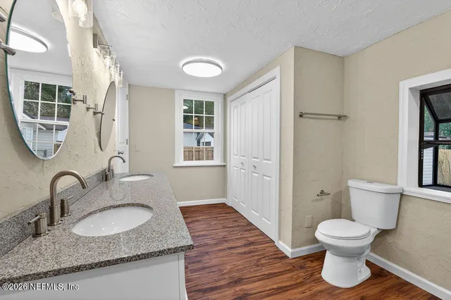 a bathroom with a granite countertop sink toilet and shower
