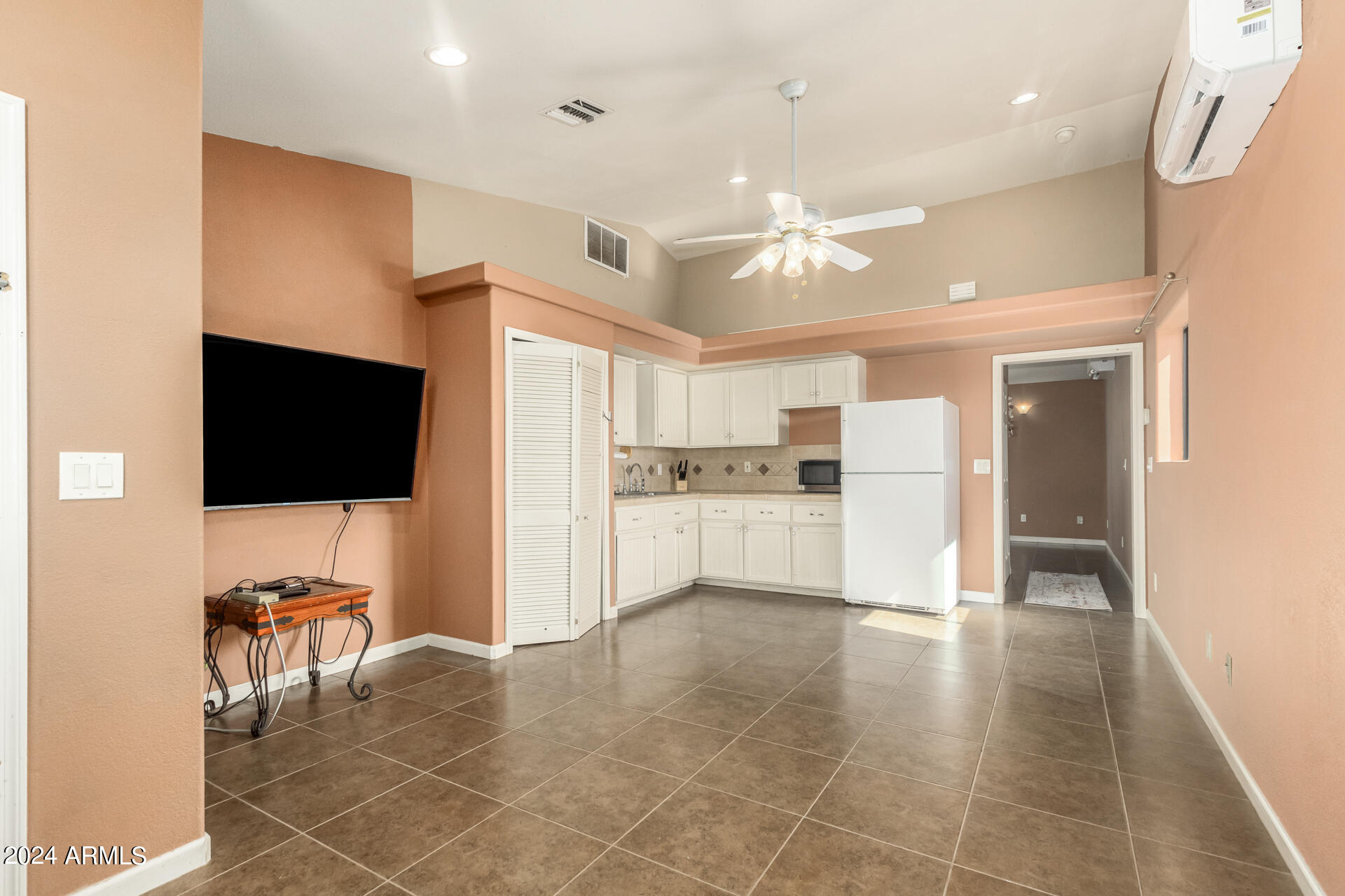 57 North Roadrunner Road Apache Junction, AZ 85119 - Photo 26 of 44 a view of open kitchen with kitchen island granite countertop a refrigerator and a stove top oven