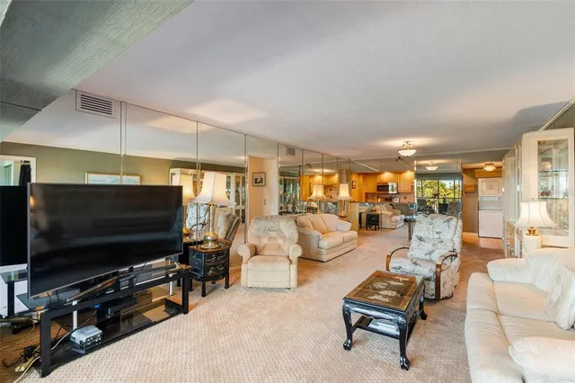 a large bedroom with a bed and wooden floor