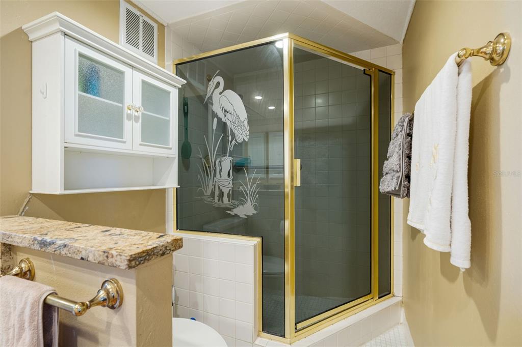 5855 Midnight Pass Road, Unit 318 Sarasota, FL 34242 - Photo 17 of 40 a bathroom with a sink and mirror
