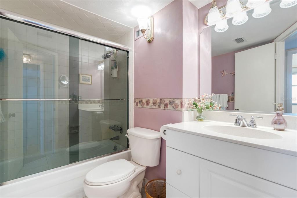 5855 Midnight Pass Road, Unit 318 Sarasota, FL 34242 - Photo 18 of 40 a bathroom with a sink a toilet and shower