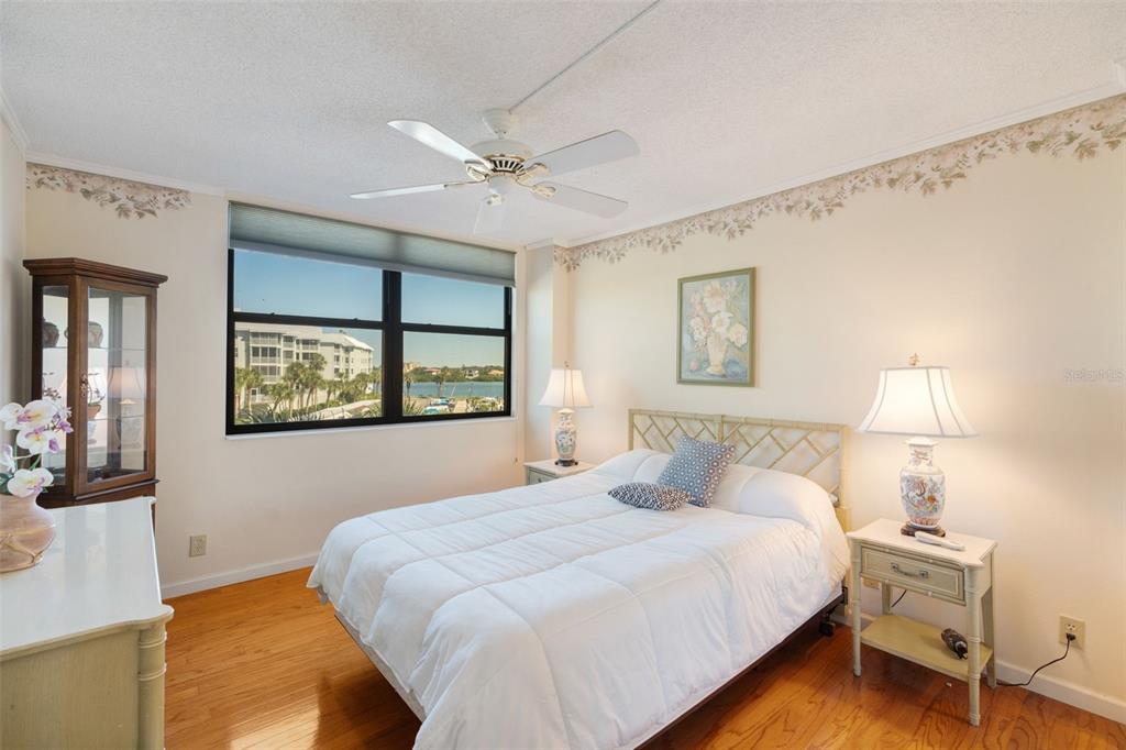 5855 Midnight Pass Road, Unit 318 Sarasota, FL 34242 - Photo 19 of 40 a bedroom with a bed and a night stand