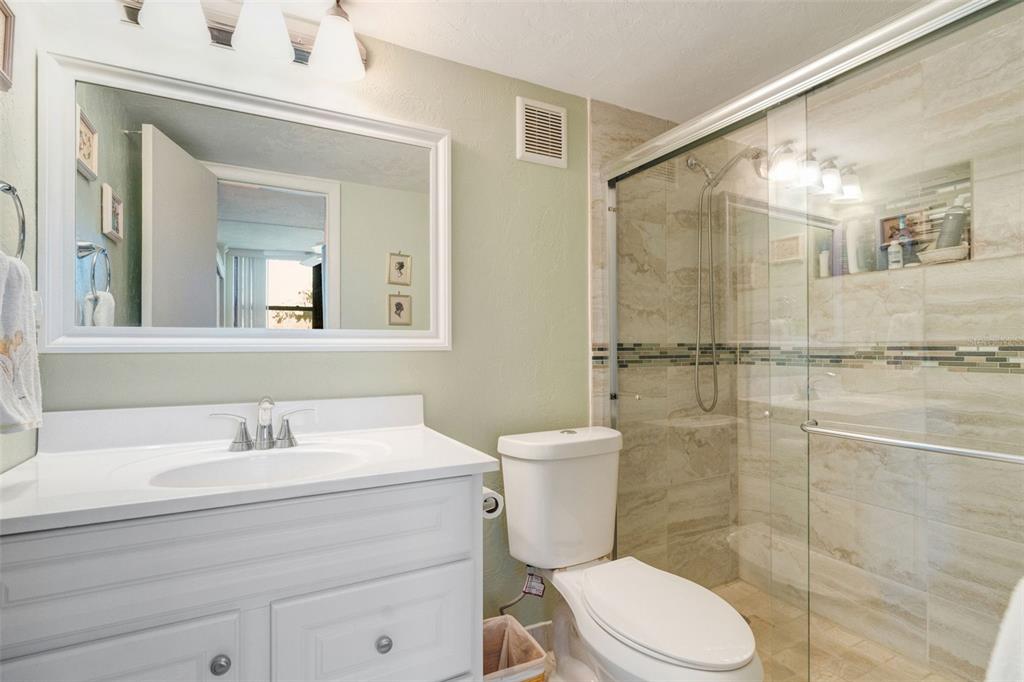 5855 Midnight Pass Road, Unit 318 Sarasota, FL 34242 - Photo 20 of 40 a bathroom with a sink toilet and shower