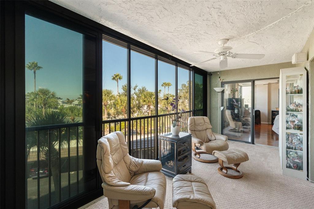 5855 Midnight Pass Road, Unit 318 Sarasota, FL 34242 - Photo 22 of 40 a living room with furniture and a floor to ceiling window