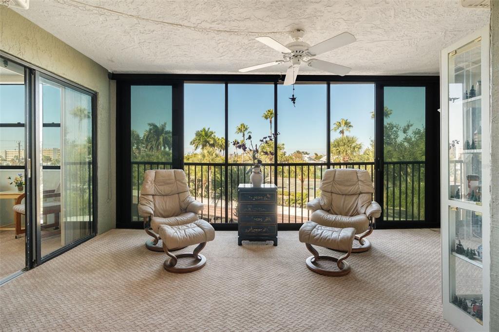 5855 Midnight Pass Road, Unit 318 Sarasota, FL 34242 - Photo 23 of 40 a living room with furniture and a floor to ceiling window