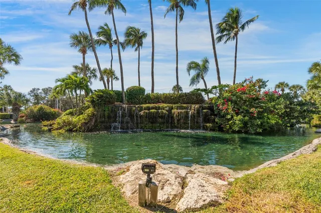 a view of a lake with a barbeque and wooden stairs