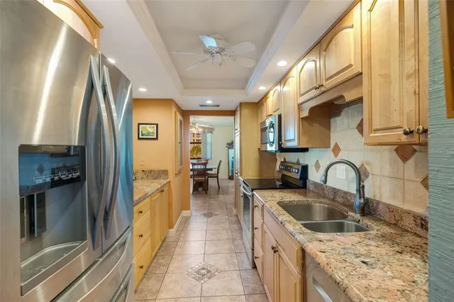 a kitchen with stainless steel appliances granite countertop a sink and cabinets