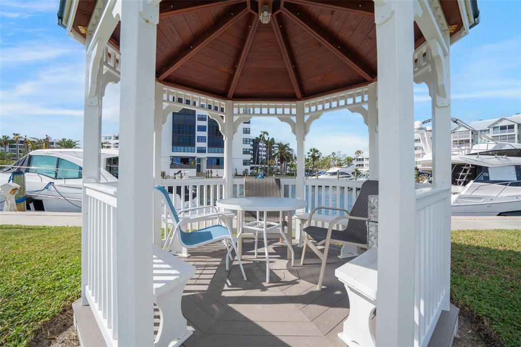 5855 Midnight Pass Road, Unit 318 Sarasota, FL 34242 - Photo 31 of 40 a table and chairs in the patio