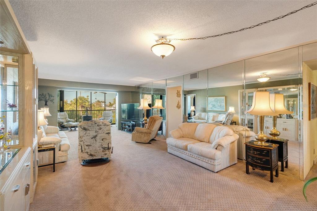 5855 Midnight Pass Road, Unit 318 Sarasota, FL 34242 - Photo 9 of 40 a living room with furniture and a large window