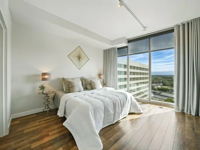 a bedroom with a bed and wooden floor