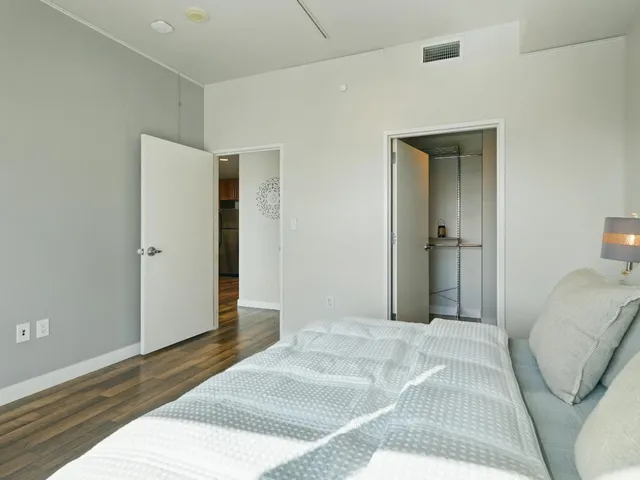 a bedroom with a bed and a mirror