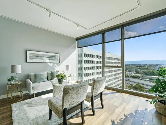a living room with furniture and a floor to ceiling window