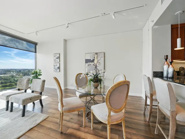 a view of a dining room with furniture window and wooden floor