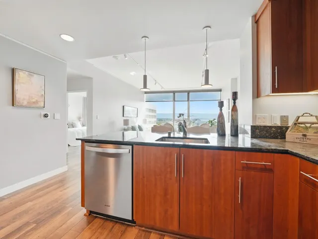 a kitchen with stainless steel appliances granite countertop wooden cabinets a sink and dishwasher