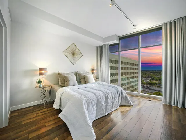 a bedroom with a large bed and a large window