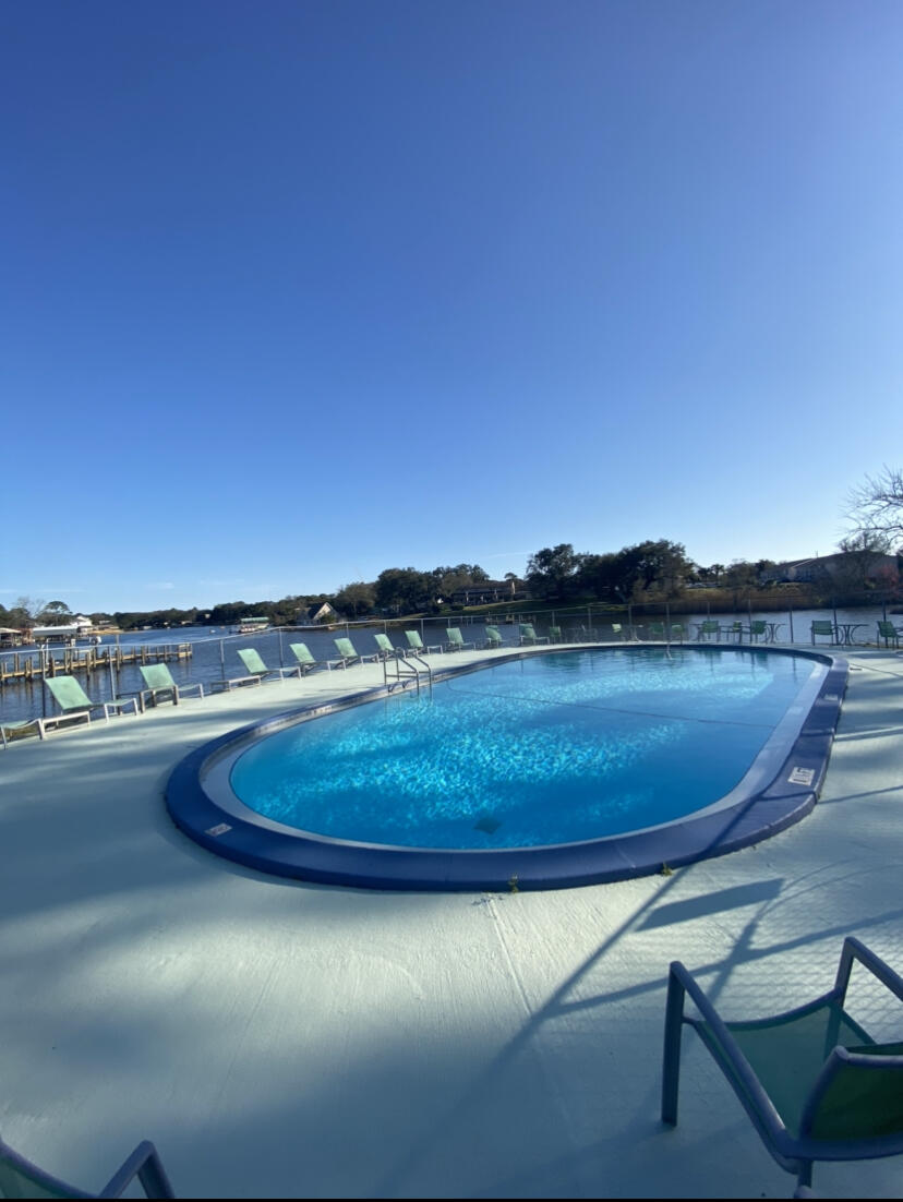 210 Pelham Road, Unit 213A Fort Walton Beach, FL 32547 - Photo 1 of 16 a view of a lake with outdoor space