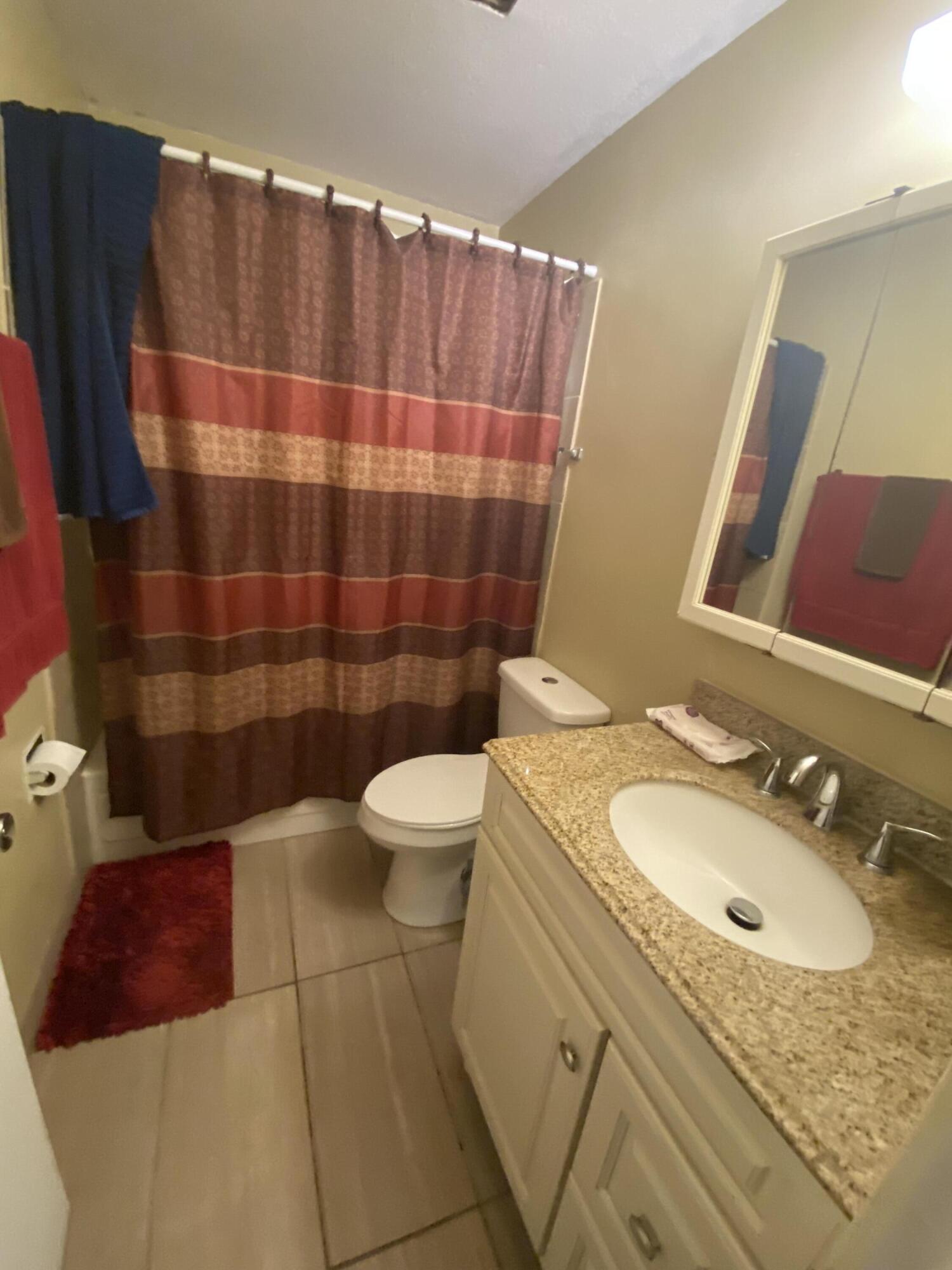 210 Pelham Road, Unit 213A Fort Walton Beach, FL 32547 - Photo 11 of 16 a bathroom with a sink toilet and shower