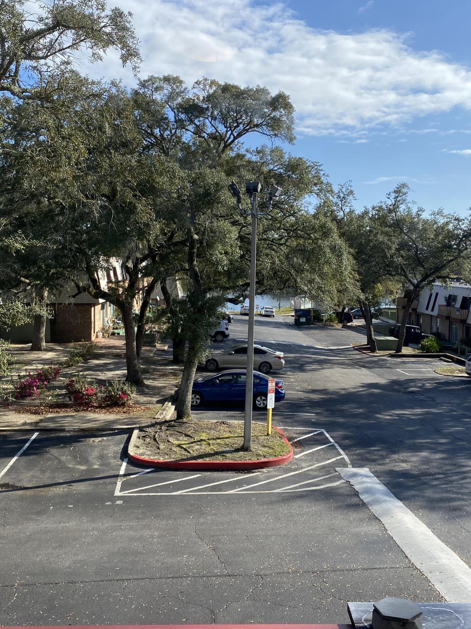 210 Pelham Road, Unit 213A Fort Walton Beach, FL 32547 - Photo 13 of 16 a view of a park with large trees